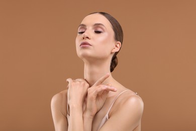 Photo of Portrait of beautiful young woman on beige background