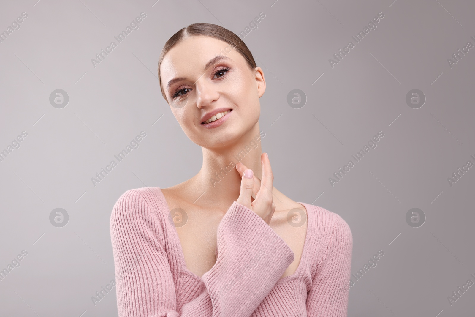 Portrait of beautiful young woman on gray background Photo of Portrait of beautiful young woman on gray background