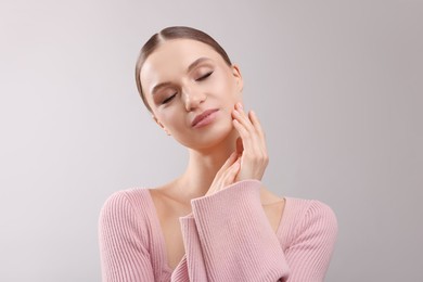 Photo of Portrait of beautiful young woman on gray background
