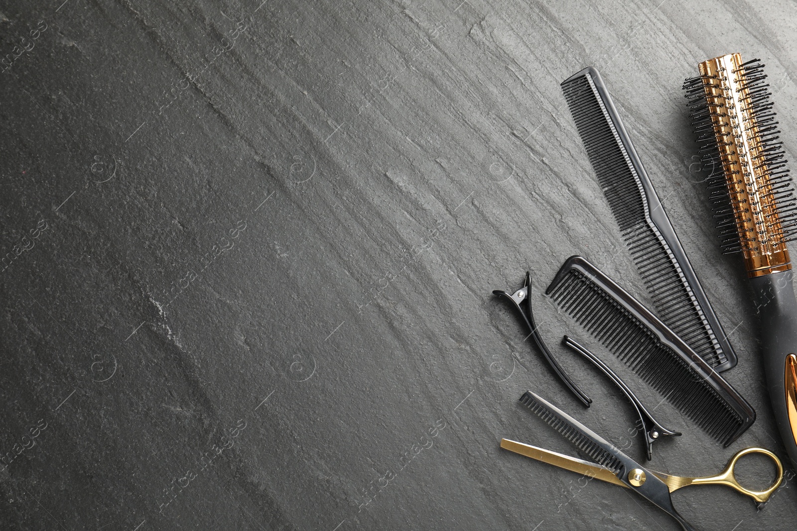 Different hairdresser's tools on dark table, flat lay. Space for text Photo of Different hairdresser's tools on dark table, flat lay. Space for text