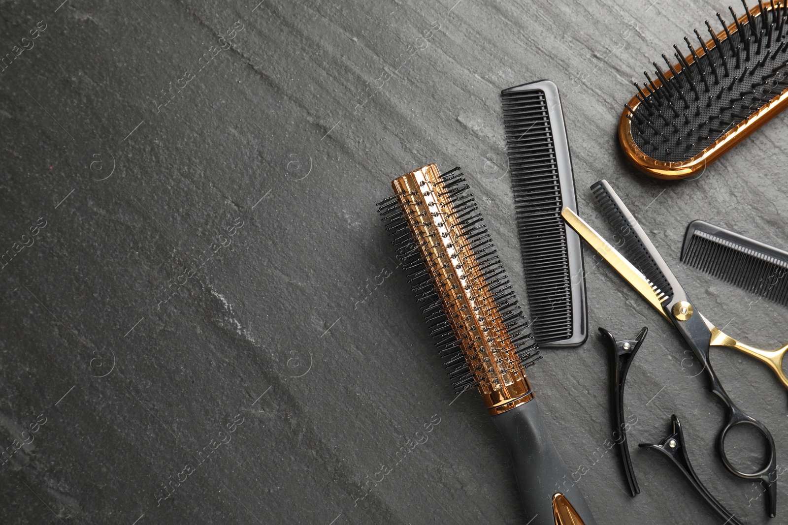 Different hairdresser's tools on dark table, flat lay. Space for text Photo of Different hairdresser's tools on dark table, flat lay. Space for text