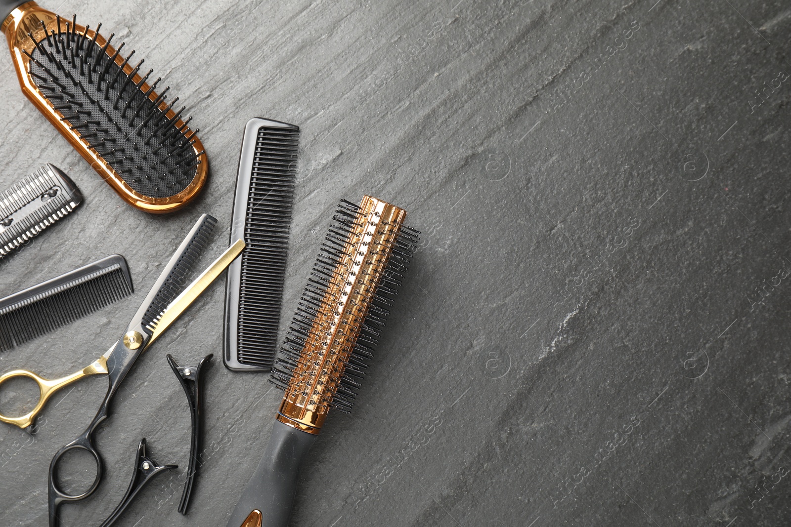 Different hairdresser's tools on dark table, flat lay. Space for text Photo of Different hairdresser's tools on dark table, flat lay. Space for text