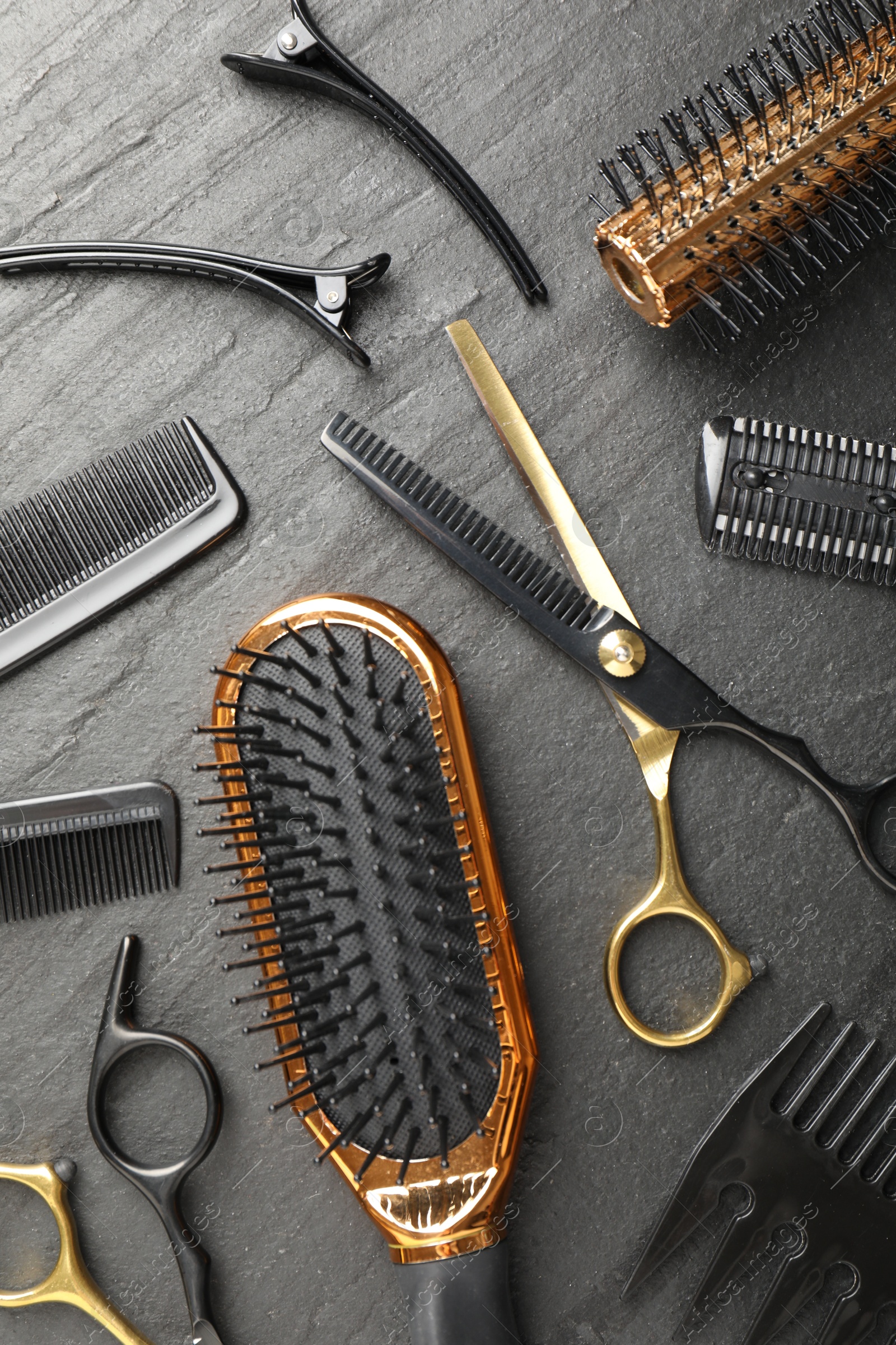 Different hairdresser's tools on dark table, flat lay Photo of Different hairdresser's tools on dark table, flat lay