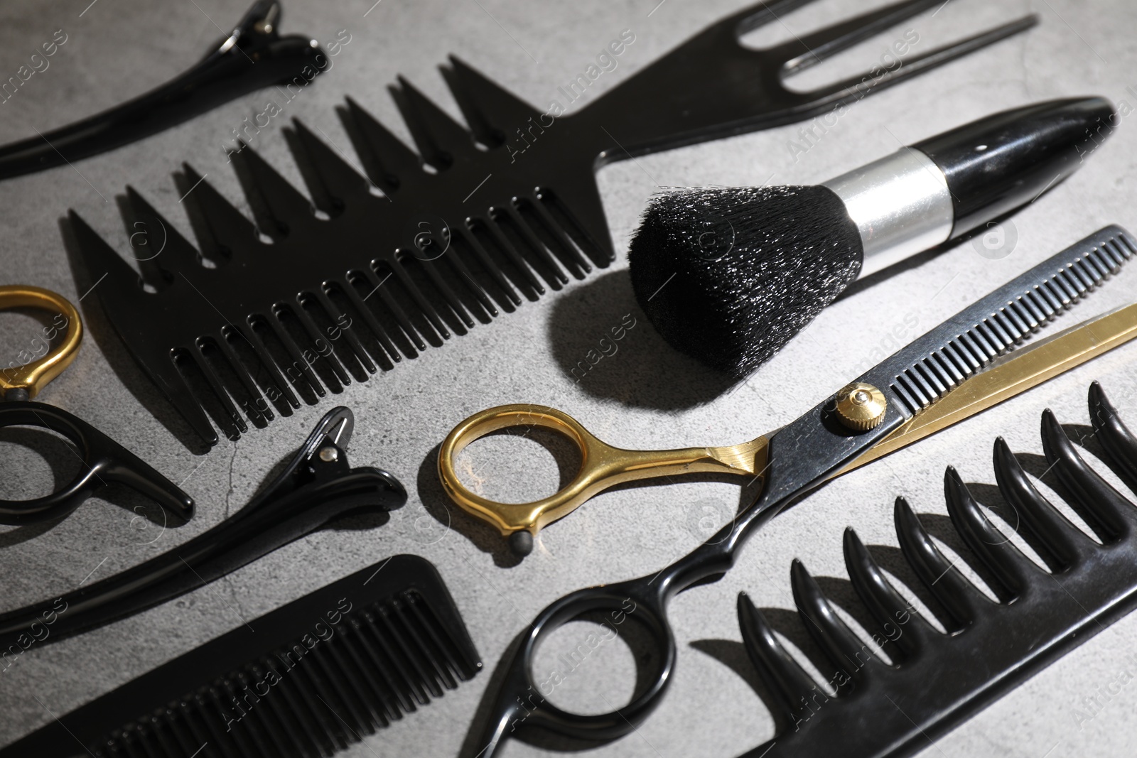 Different hairdresser's tools on grey table, closeup Photo of Different hairdresser's tools on grey table, closeup