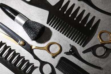 Photo of Different hairdresser's tools on grey table, flat lay