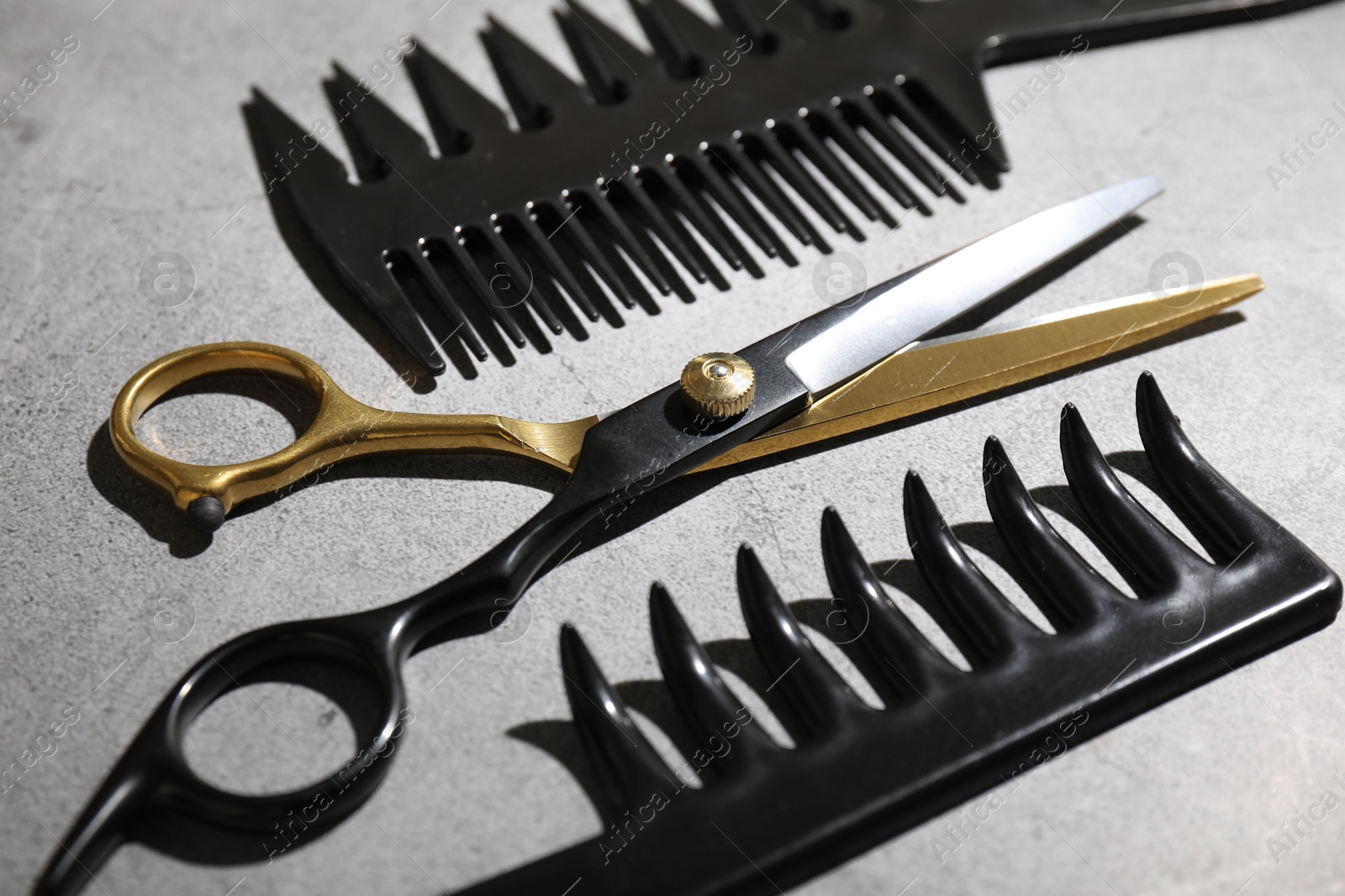 Different hairdresser's tools on grey table, closeup Photo of Different hairdresser's tools on grey table, closeup