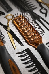 Photo of Different hairdresser's tools on grey table, closeup