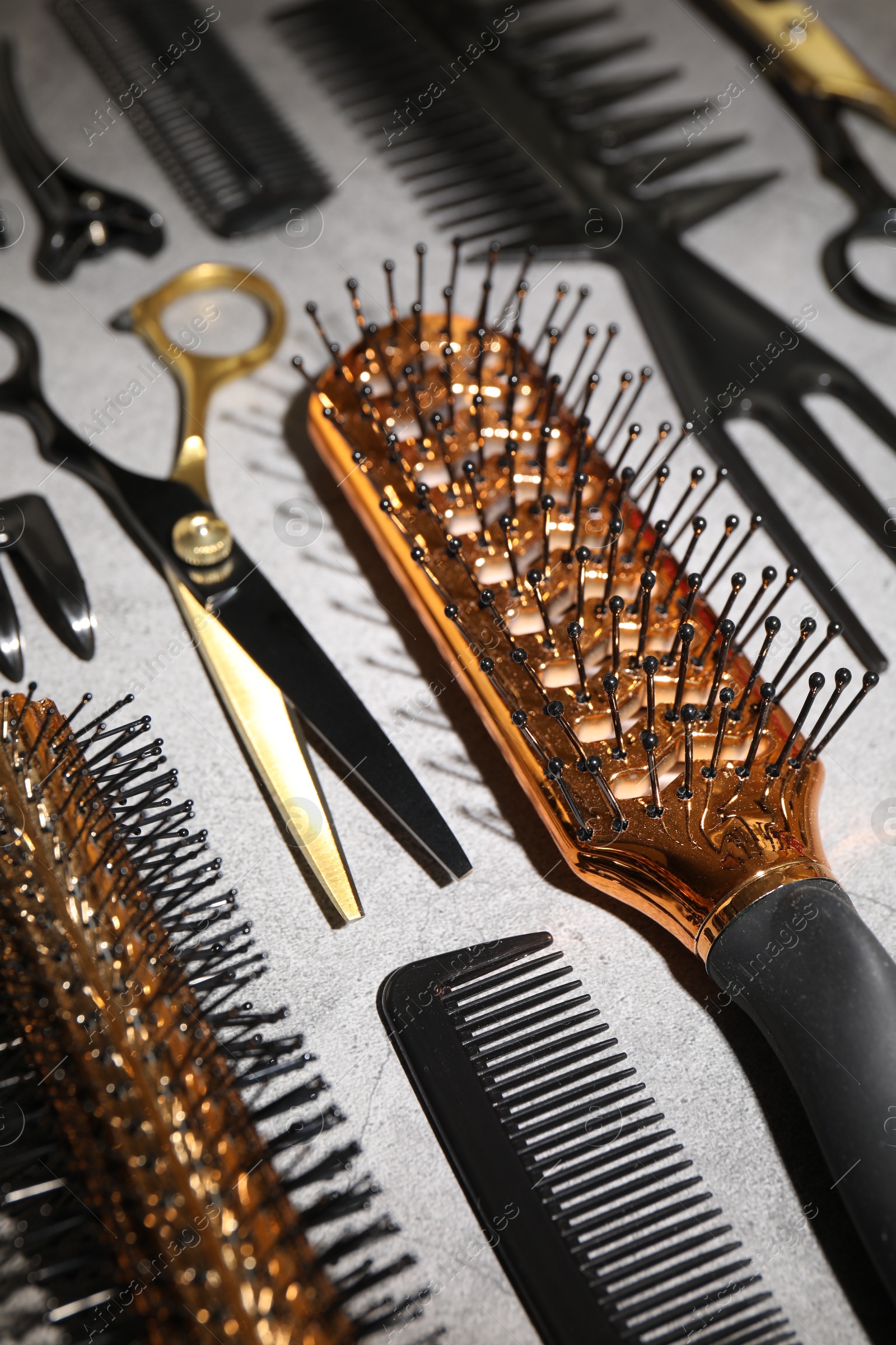 Different hairdresser's tools on grey table, closeup Photo of Different hairdresser's tools on grey table, closeup