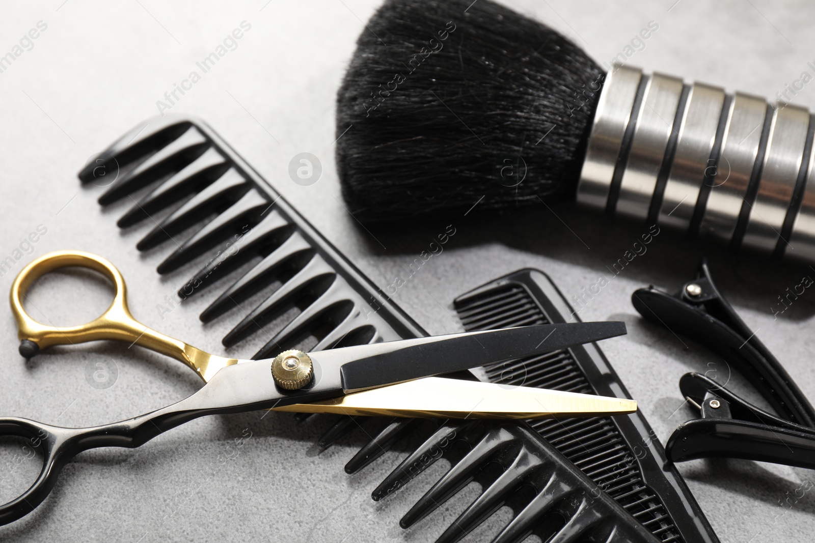Different hairdresser's tools on grey table, closeup Photo of Different hairdresser's tools on grey table, closeup