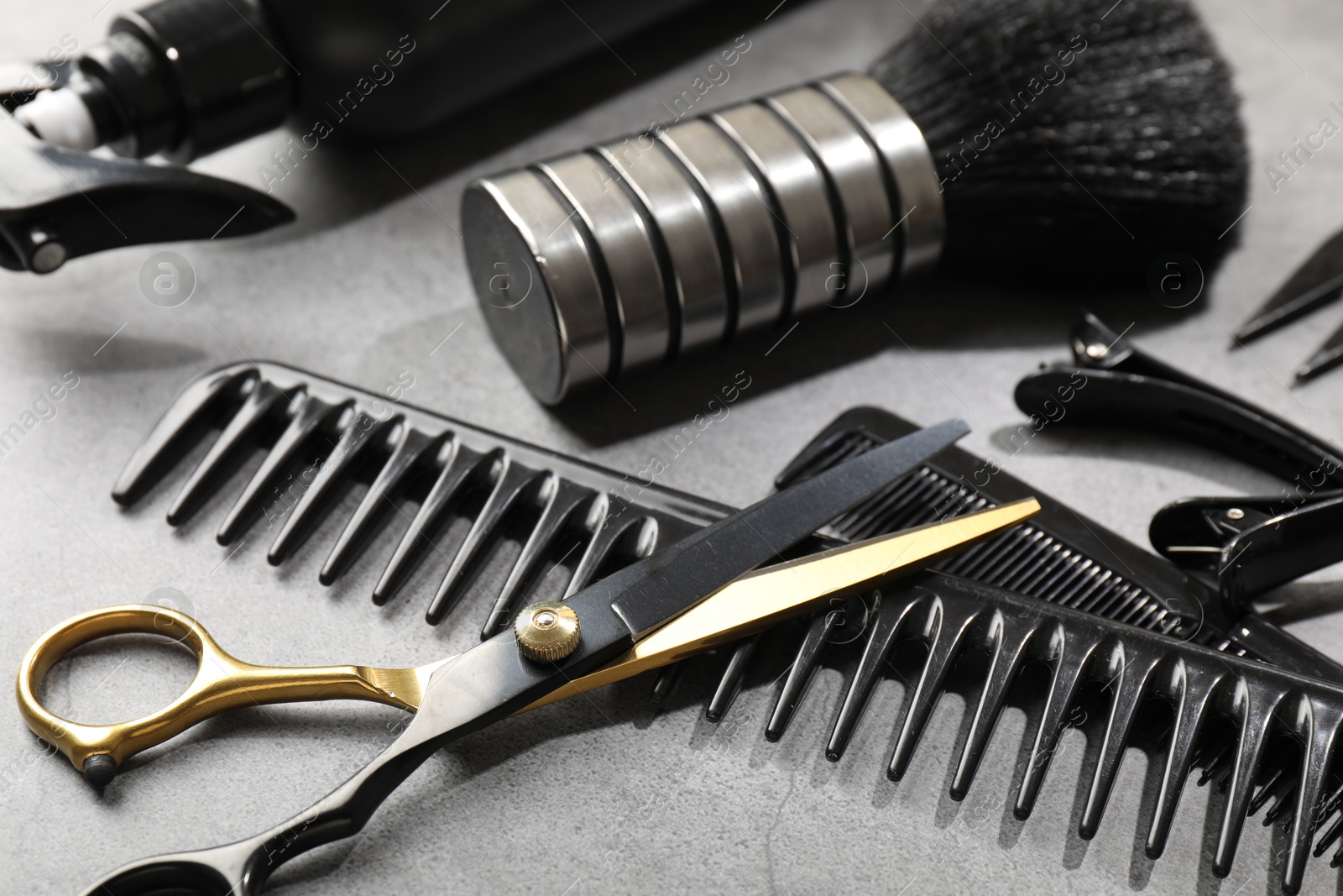 Different hairdresser's tools on grey table, closeup Photo of Different hairdresser's tools on grey table, closeup