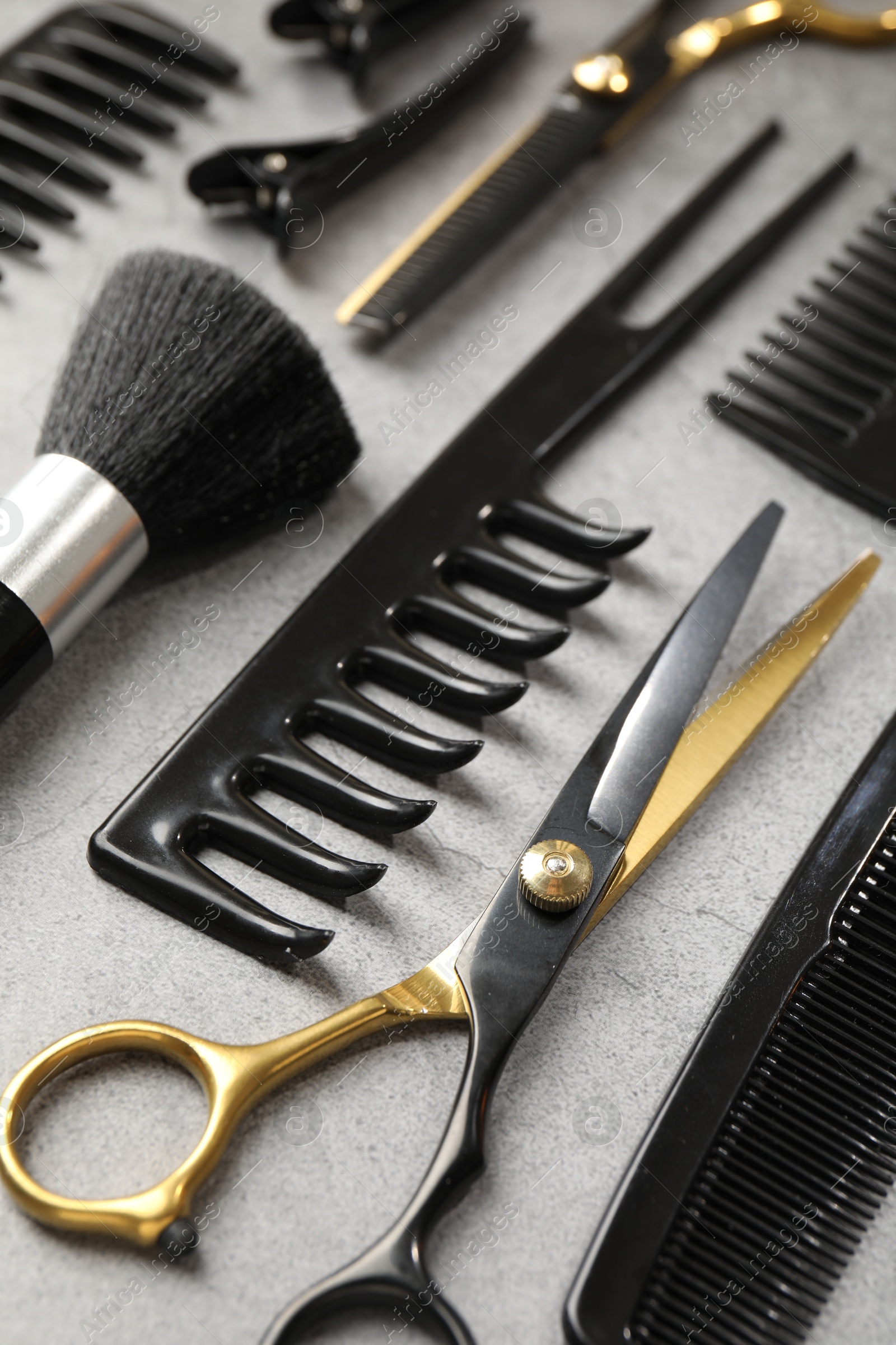 Different hairdresser's tools on grey table, closeup Photo of Different hairdresser's tools on grey table, closeup