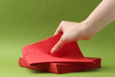Photo of Woman with handkerchiefs on green background, closeup. Space for text