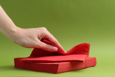 Photo of Woman with handkerchiefs on green background, closeup. Space for text