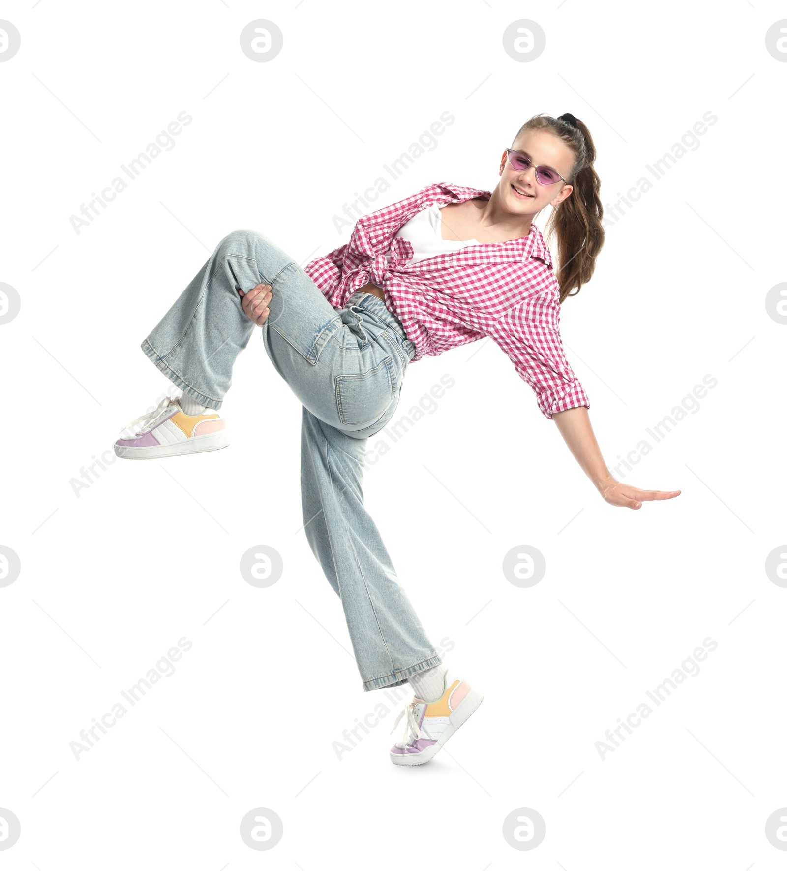 Girl in stylish clothes and sunglasses dancing on white background Photo of Girl in stylish clothes and sunglasses dancing on white background