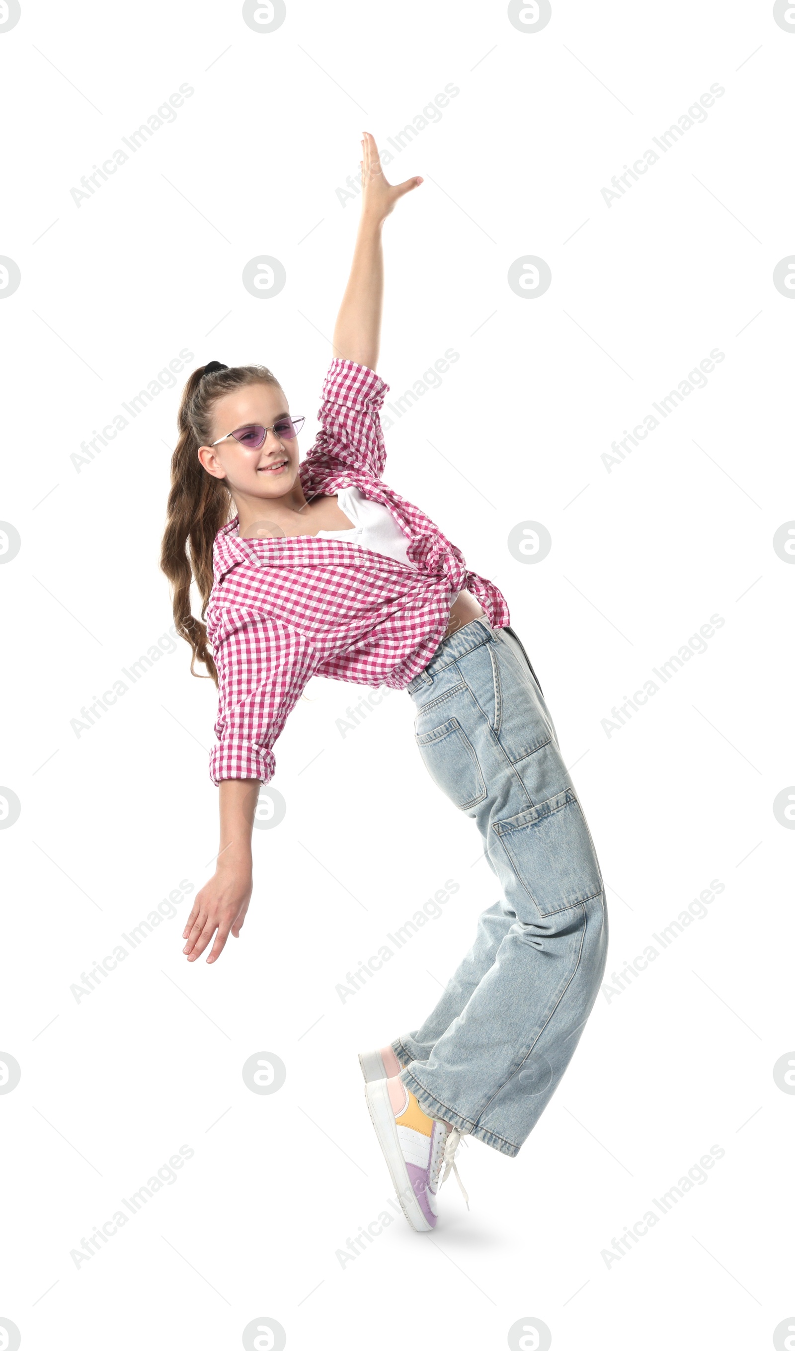 Girl in stylish clothes and sunglasses dancing on white background Photo of Girl in stylish clothes and sunglasses dancing on white background