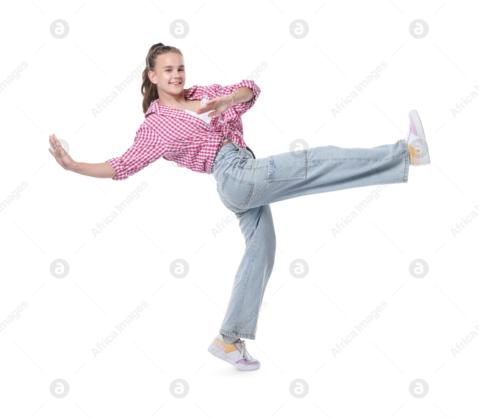 Girl in stylish clothes dancing on white background Photo of Girl in stylish clothes dancing on white background