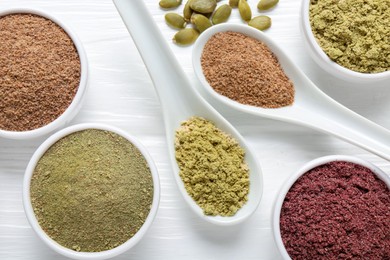Photo of Different superfoods on white wooden table, flat lay