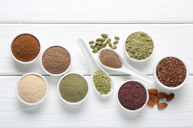 Photo of Different superfoods on white wooden table, flat lay