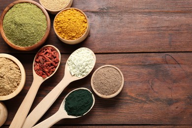 Photo of Different superfoods on wooden table, flat lay. Space for text