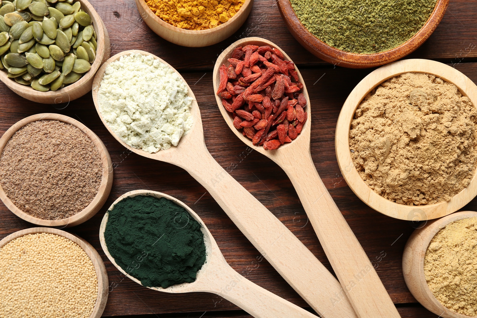 Different superfoods on wooden table, flat lay Photo of Different superfoods on wooden table, flat lay
