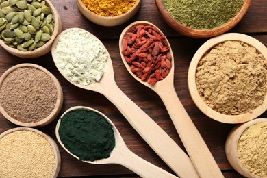 Photo of Different superfoods on wooden table, flat lay