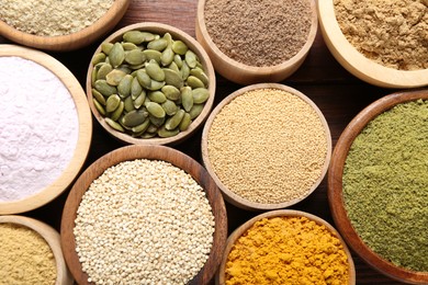 Photo of Different superfoods in bowls on table, flat lay