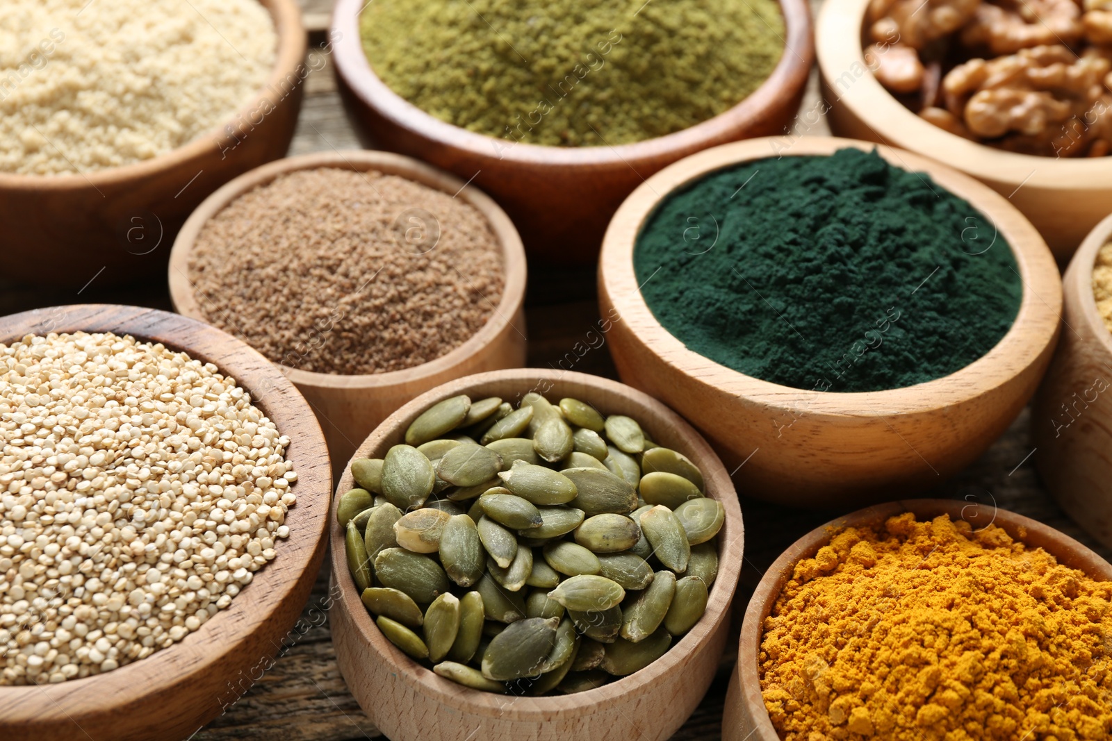 Different superfood products in bowls on table, closeup Photo of Different superfood products in bowls on table, closeup