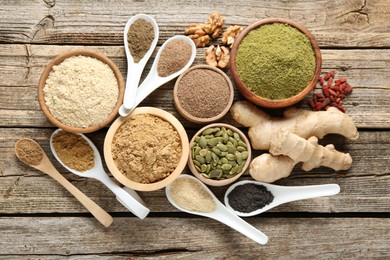 Photo of Different superfood products on wooden table, flat lay