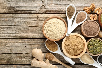 Photo of Different superfood products on wooden table, flat lay. Space for text