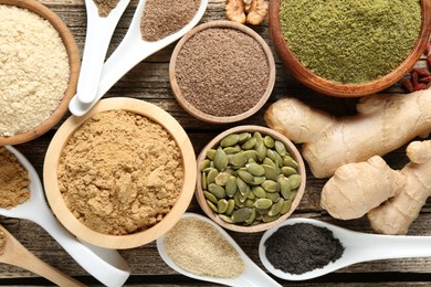 Photo of Different superfood products on wooden table, flat lay