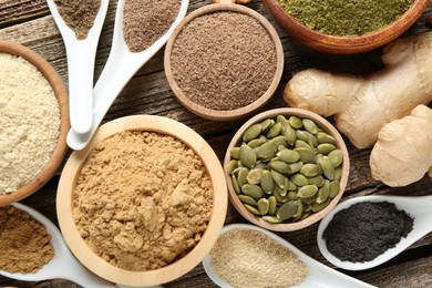 Photo of Different superfood products on wooden table, flat lay