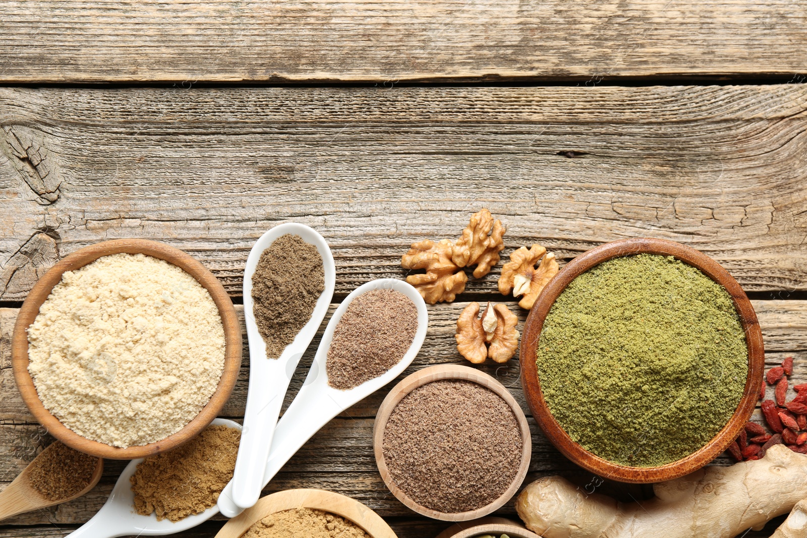 Different superfoods on wooden table, flat lay. Space for text Photo of Different superfoods on wooden table, flat lay. Space for text