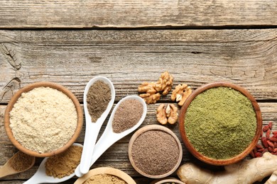 Photo of Different superfoods on wooden table, flat lay. Space for text