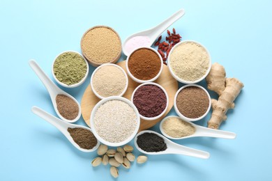 Photo of Different superfoods on light blue background, flat lay
