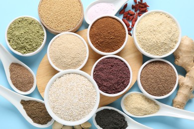 Photo of Different superfoods on light blue background, flat lay