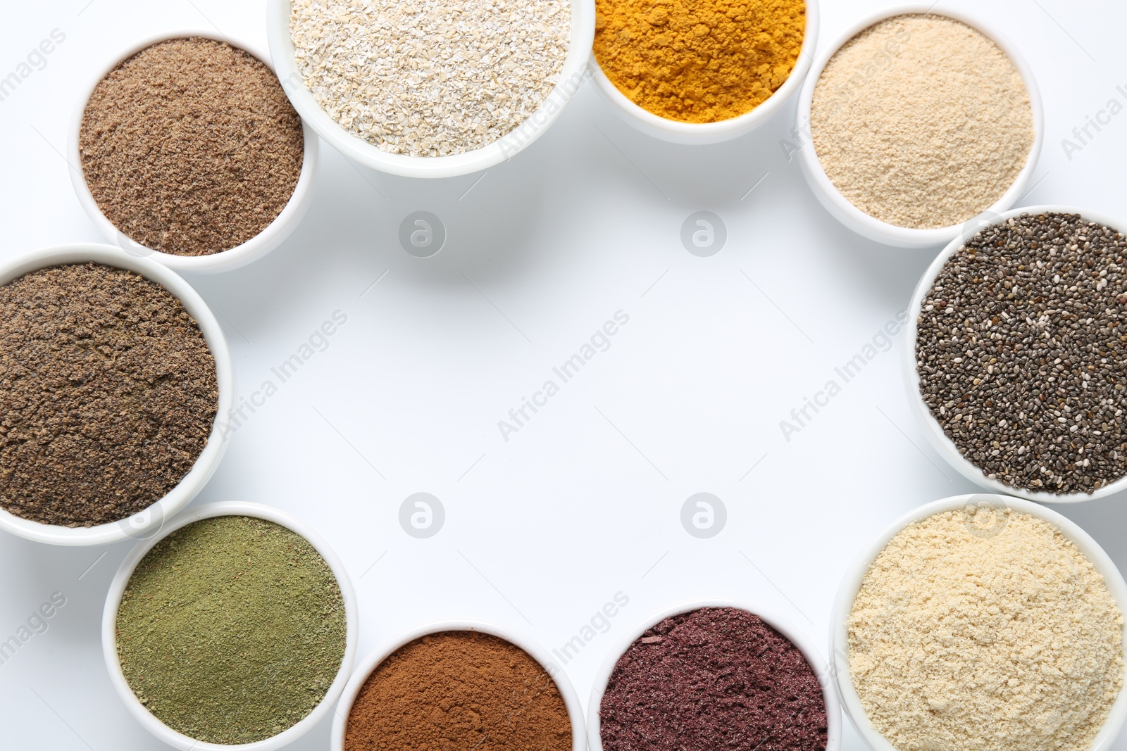 Frame of different superfood powders in bowls on white background, flat lay. Space for text Photo of Frame of different superfood powders in bowls on white background, flat lay. Space for text