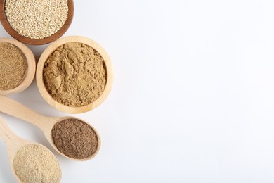 Photo of Different superfood powders in bowls and spoons on white background, flat lay. Space for text