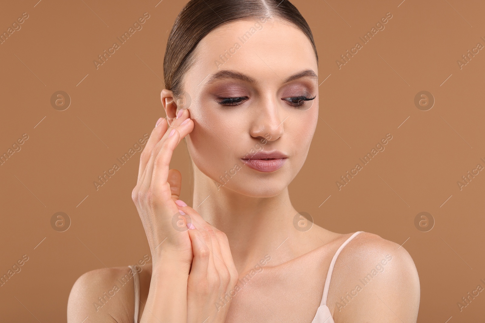 Portrait of beautiful young woman on beige background Photo of Portrait of beautiful young woman on beige background