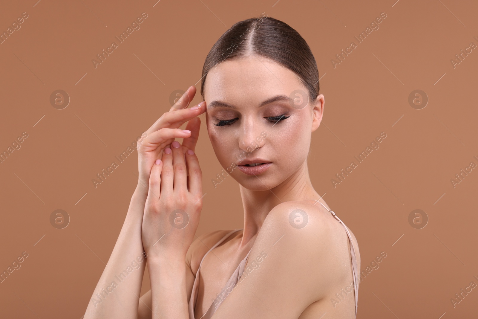 Portrait of beautiful young woman on beige background Photo of Portrait of beautiful young woman on beige background