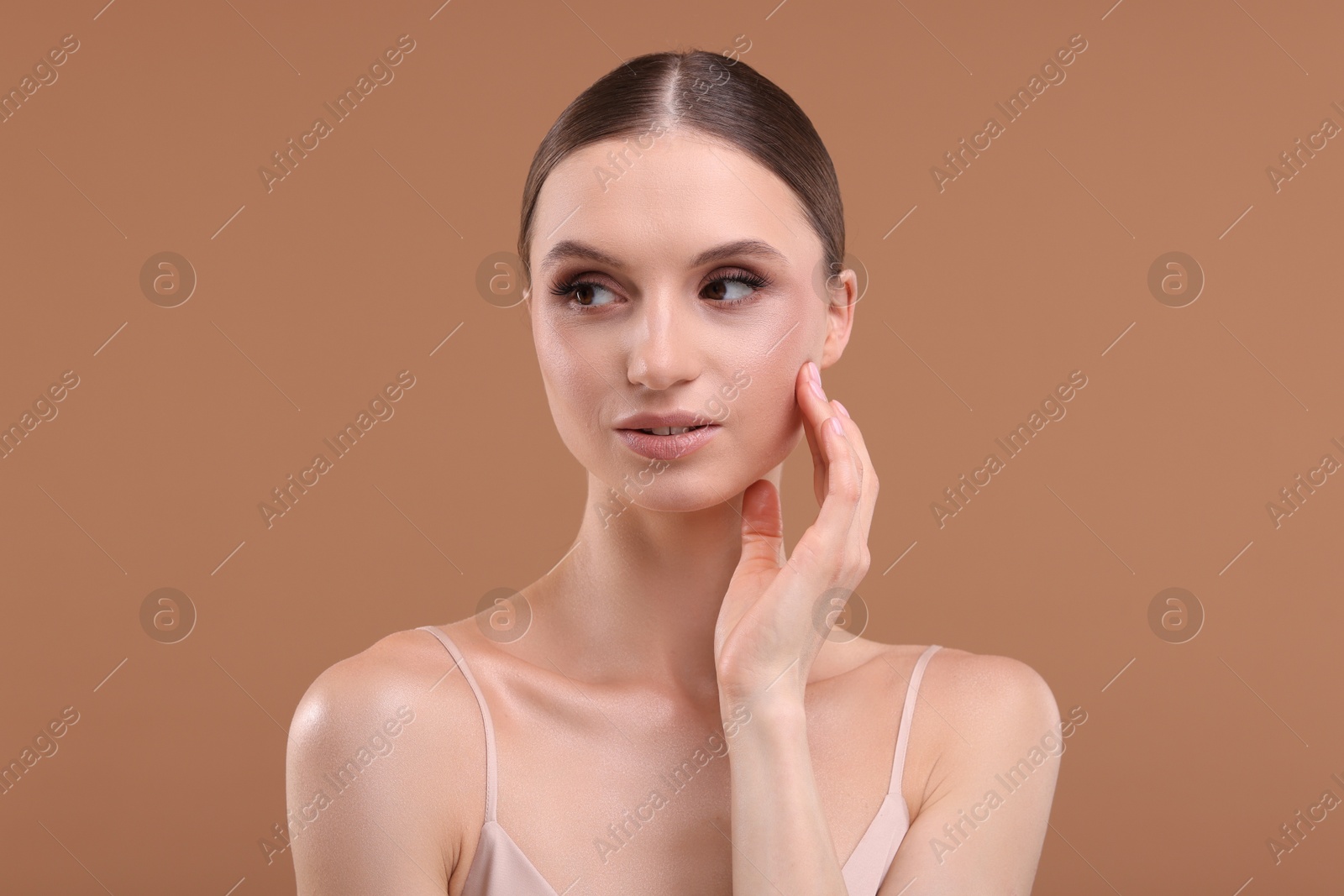Portrait of beautiful young woman on beige background Photo of Portrait of beautiful young woman on beige background