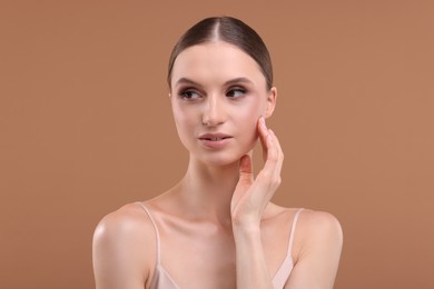Photo of Portrait of beautiful young woman on beige background