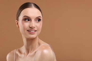 Photo of Portrait of beautiful young woman on beige background, space for text