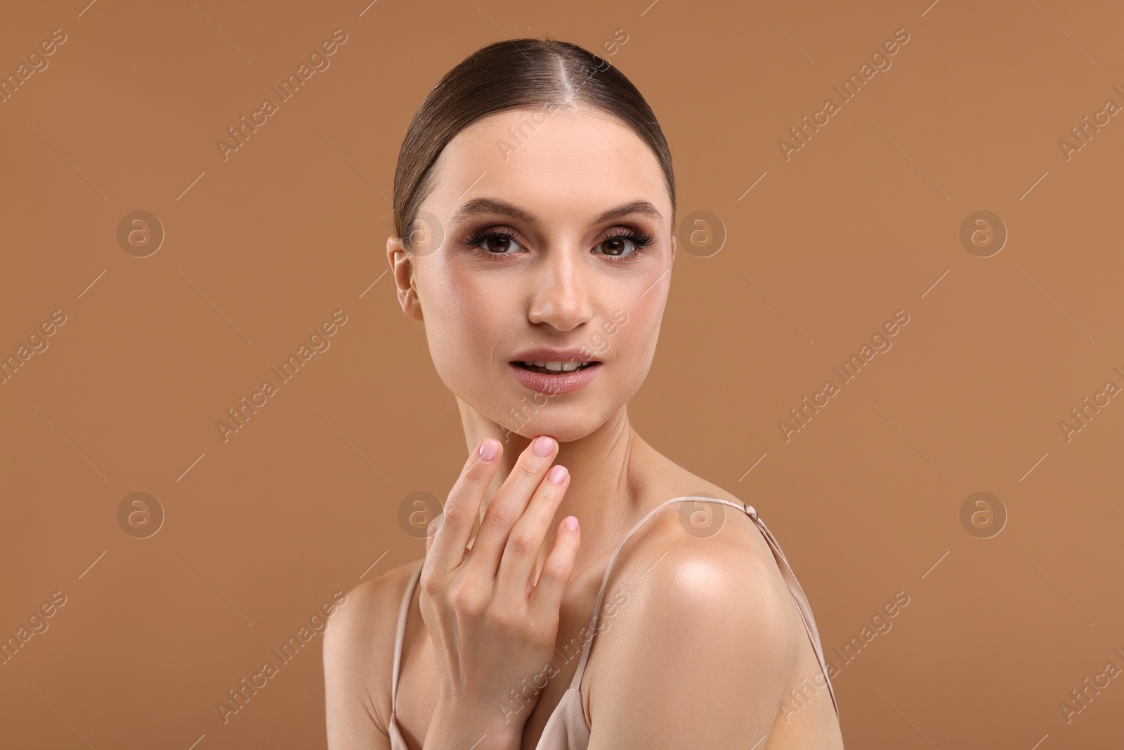 Portrait of beautiful young woman on beige background Photo of Portrait of beautiful young woman on beige background