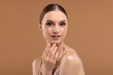 Photo of Portrait of beautiful young woman on beige background