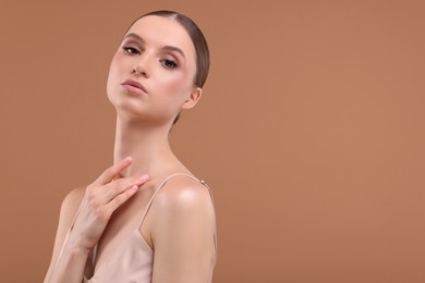 Photo of Portrait of beautiful young woman on beige background, space for text