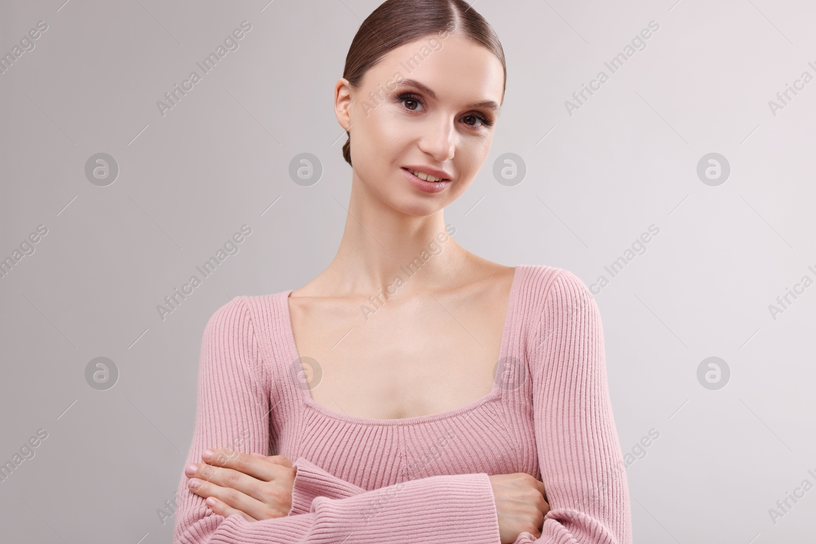 Portrait of beautiful young woman on gray background Photo of Portrait of beautiful young woman on gray background