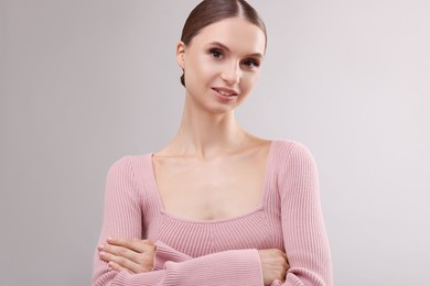 Photo of Portrait of beautiful young woman on gray background
