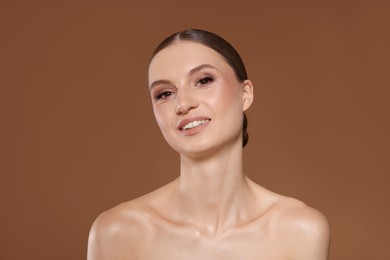 Photo of Portrait of beautiful young woman on beige background