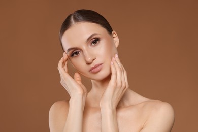 Photo of Portrait of beautiful young woman on beige background