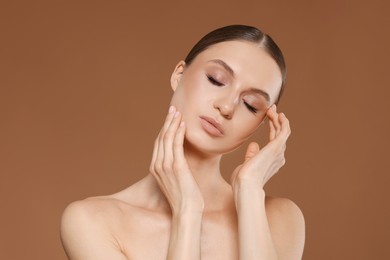 Photo of Portrait of beautiful young woman on beige background